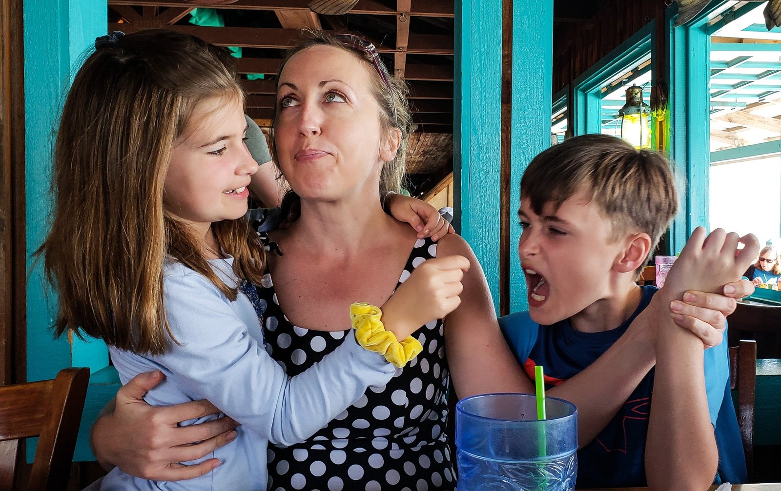 Candids in public places with kids being kids with mother in the middle as referees in stress.